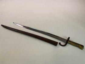 A French M 1866 chassepot bayonet, with brass handle and original scabbard, numbers embossed into