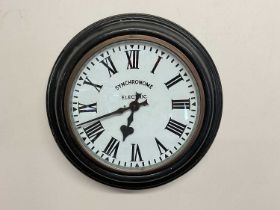 SYNCHRONOME; an electric metal and glazed wall clock with enamel dial, set with Roman numerals,