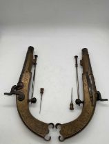 A pair of early 19th century Scottish brass framed 120 bore percussion cap pistols with foliate