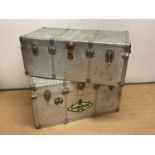 Two aluminium travelling trunks with rivet detailing, larger height 53cm, width 102cm, depth 53cm.