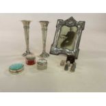 A group of small hallmarked silver items comprising photograph frame, pair of bud vases, an enamel