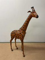 IN THE STYLE OF LIBERTY OF LONDON; a large leather giraffe, height 137cm.