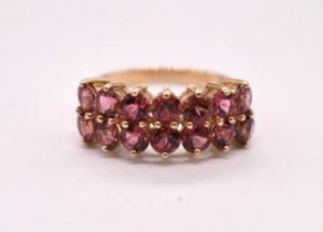 A 9ct yellow gold dress ring set with two rows of pale pink stones, size N, approx. 3.06g.
