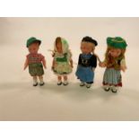 A small collection of celluloid clockwork dancing dolls, a German boy in lederhosen, and three girls