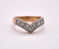 An 18ct yellow gold and platinum tipped seven stone diamond wishbone ring, total diamond weight