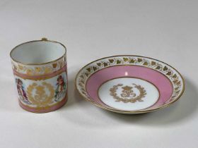 SÈVRES; a late 19th century cabinet cup and saucer, gilt heightened on a pink ground with