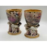 KPM; a pair of porcelain beakers, each with gilt washed interior, hand painted with classical