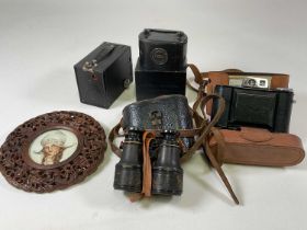 A cased Agfa camera, a pair of field glasses, a box camera, money box and a carved Chinese