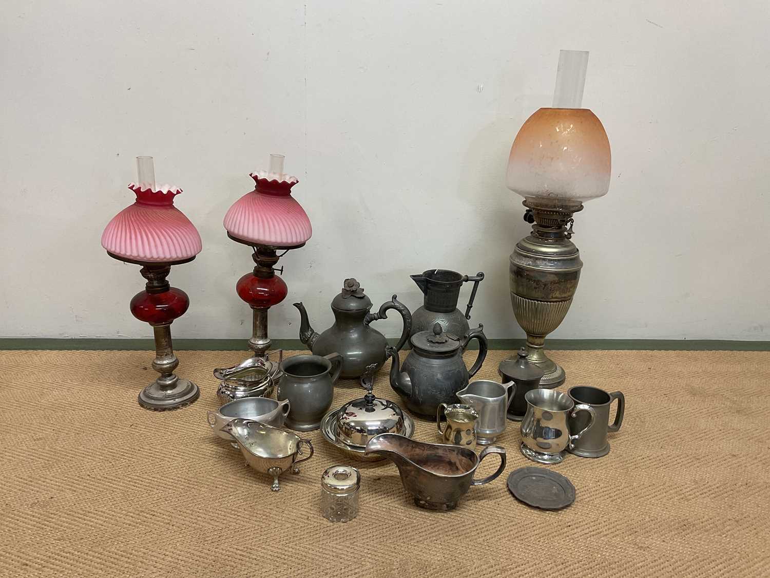 A quantity of plated ware, a silver topped dressing table pot, pewter and three oil lamps with glass