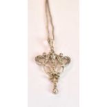 An Edwardian Belle Epoque white metal diamond set pendant with scroll open design suspended on a