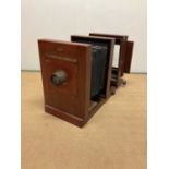 Large mahogany studio camera, on expanding base, length 60cm, width 33cm.