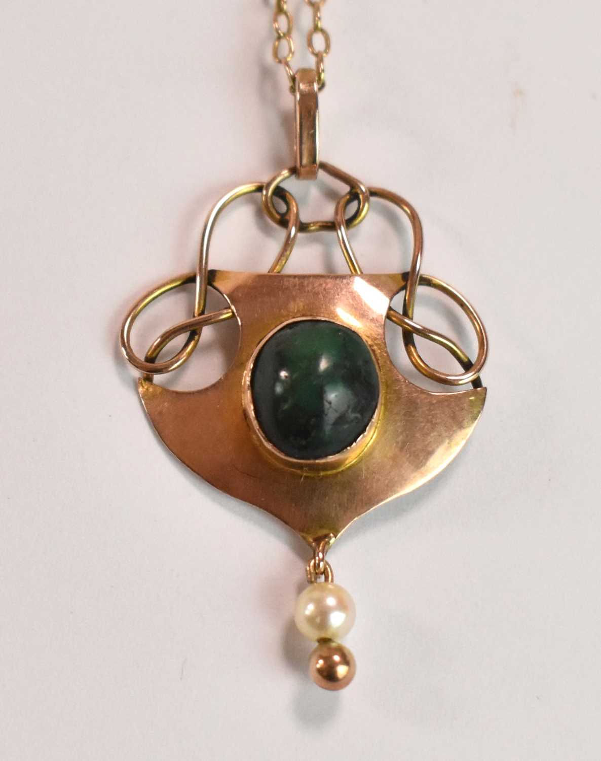 IN THE MANNER OF MURRLE BENNETT; a 9ct gold turquoise and seed pearl Art Nouveau pendant suspended