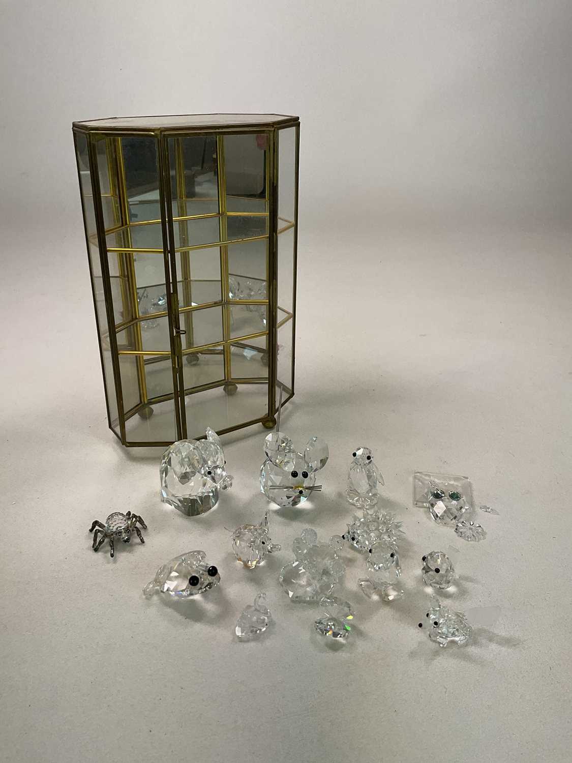 SWAROVSKI; a collection of Swarovski and other animals presented in a mirrored glass case, height