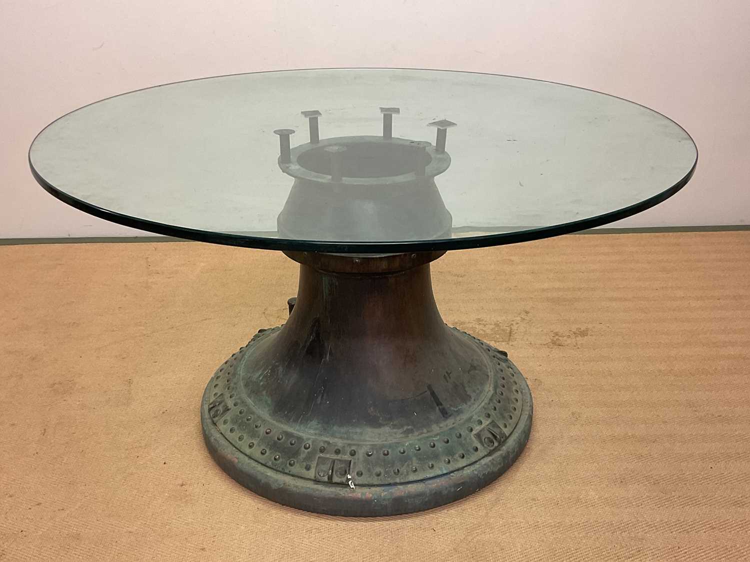 A dining/centre table incorporating the top section of a whisky still, with circular glass top,