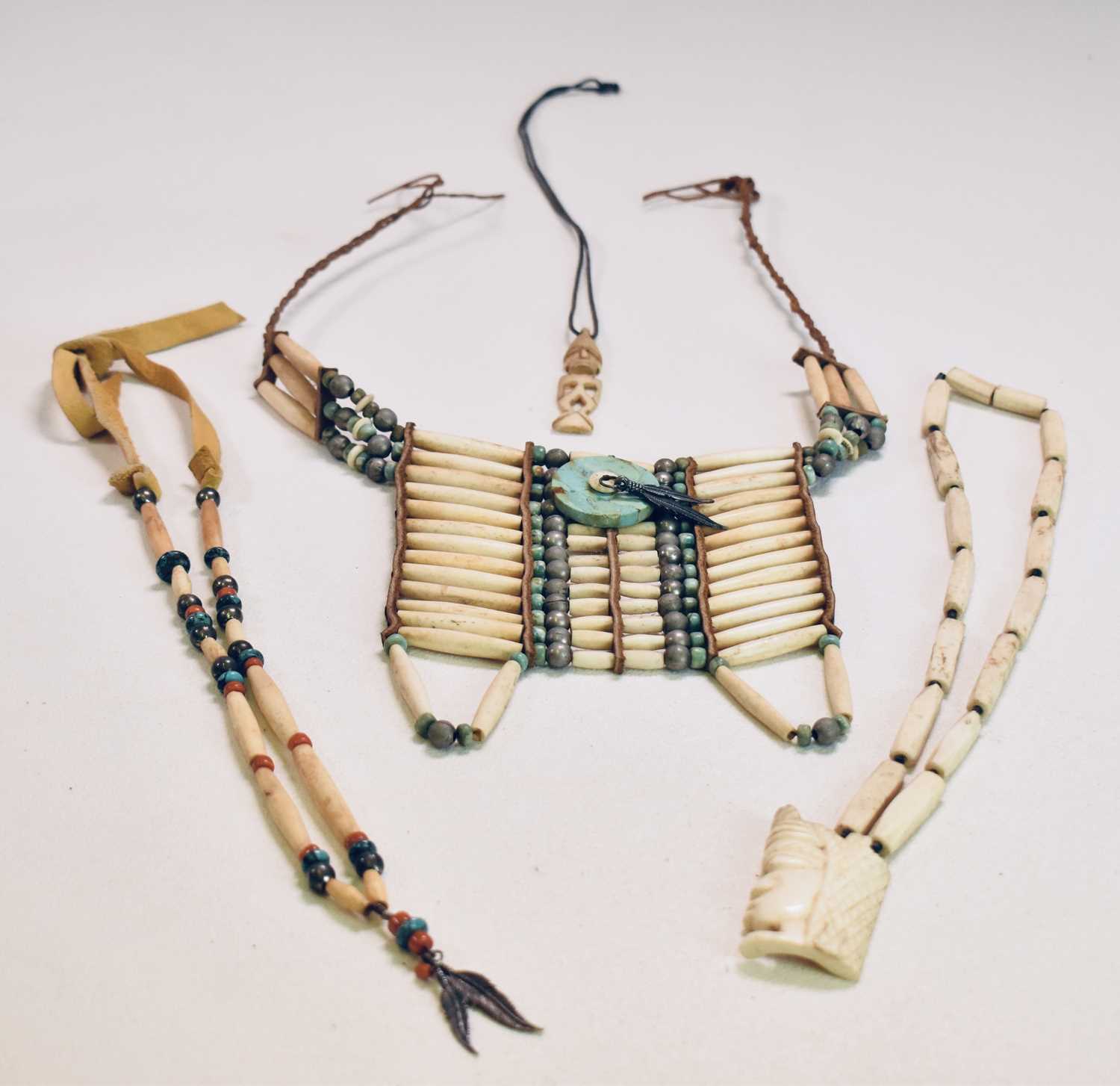 NAVAJO/NATIVE AMERICAN; a bone white metal and turquoise neckpiece, two carved bone necklaces, one