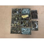 Ten small trays of furniture fittings, to include brass hinges, clips, brackets and door handles