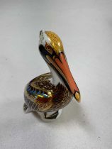 ROYAL CROWN DERBY; a Brown Pelican paperweight with a gold stopper, boxed