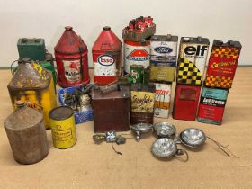 A collection of automobilia to include oil drums, oil cans, headlamps, badges, for Elf, Shell,