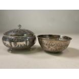 An Indian white metal circular lidded bowl, the border decorated with various animals and with