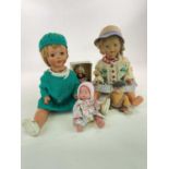 A group of five dolls including a 22" 1940s composition doll with sleeping eyes and pierced ears (