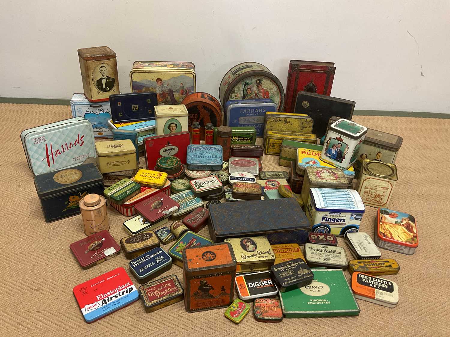 A large quantity of vintage tins including tobacco tins, biscuit tins, Quality Street, commemorative