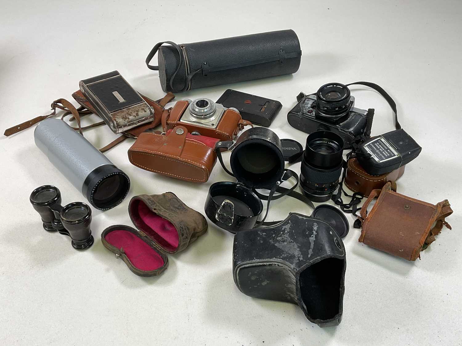 A collection of various cameras and lenses.