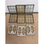 Six copper framed windows, 38 x 28cm, and six cast iron decorative panels, 30 x 26cm.