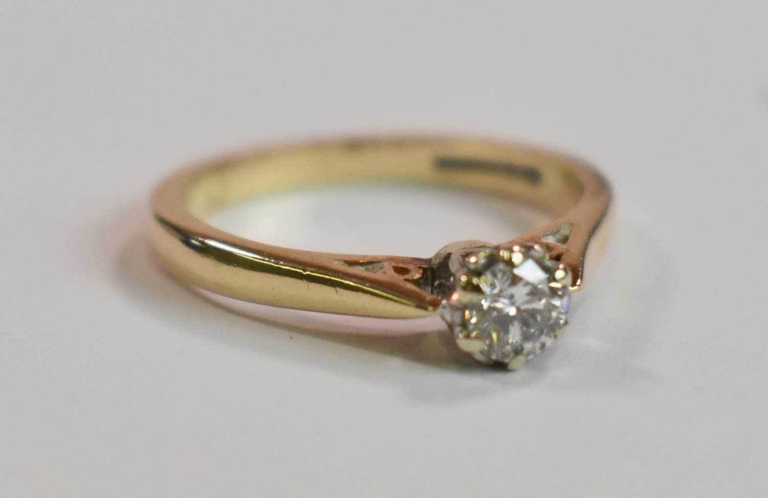 An 18ct yellow gold diamond solitaire ring, the round brilliant cut stone weighing 0.25ct, size M,