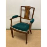 An Edwardian mahogany inlaid elbow chair.
