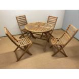 A wooden garden table, diameter 90cm, and four seats (af).