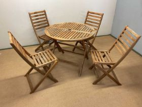 A wooden garden table, diameter 90cm, and four seats (af).