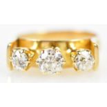 An 18ct yellow gold three stone diamond ring with unusual raised setting formed of three old