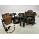 A collection of vintage telephones including three bakelite phones with rotary dials, a Sterdy