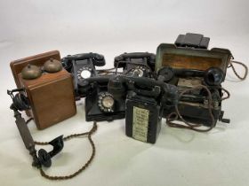 A collection of vintage telephones including three bakelite phones with rotary dials, a Sterdy