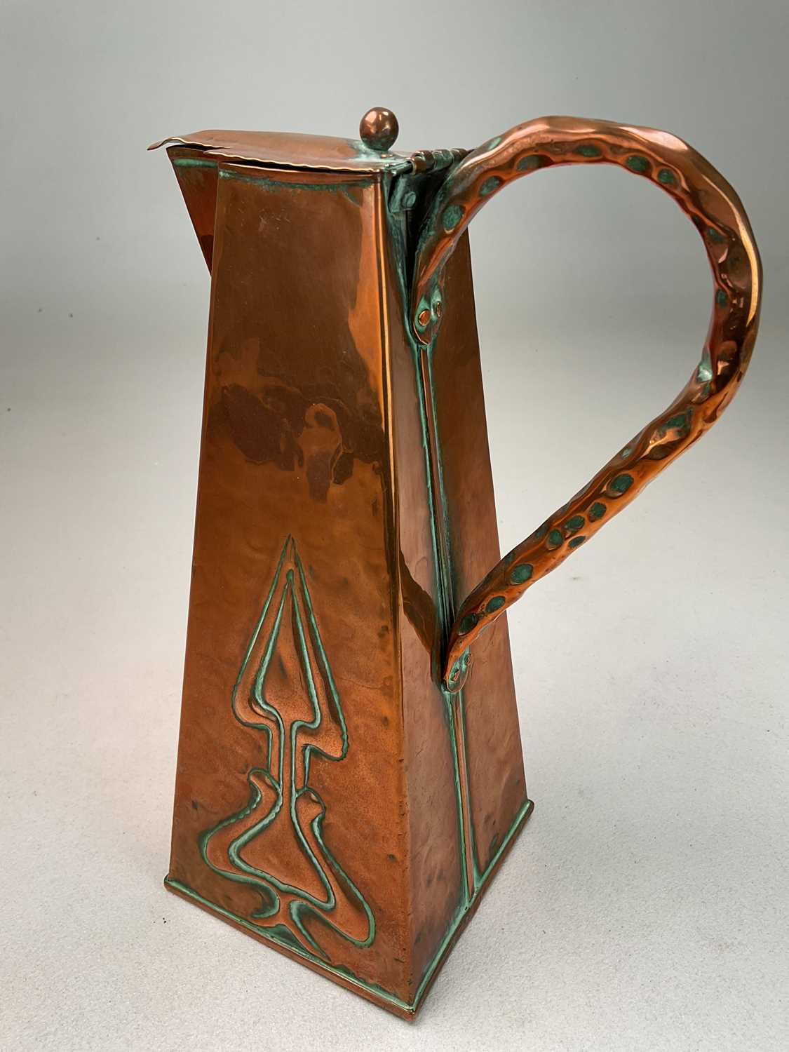 An Arts and Crafts copper water jug with tapered body embossed with stylized plants, height 28cm, - Image 2 of 4