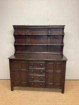 ERCOL; a stained dresser with shelves over a two door and four drawer base, height 171cm, width
