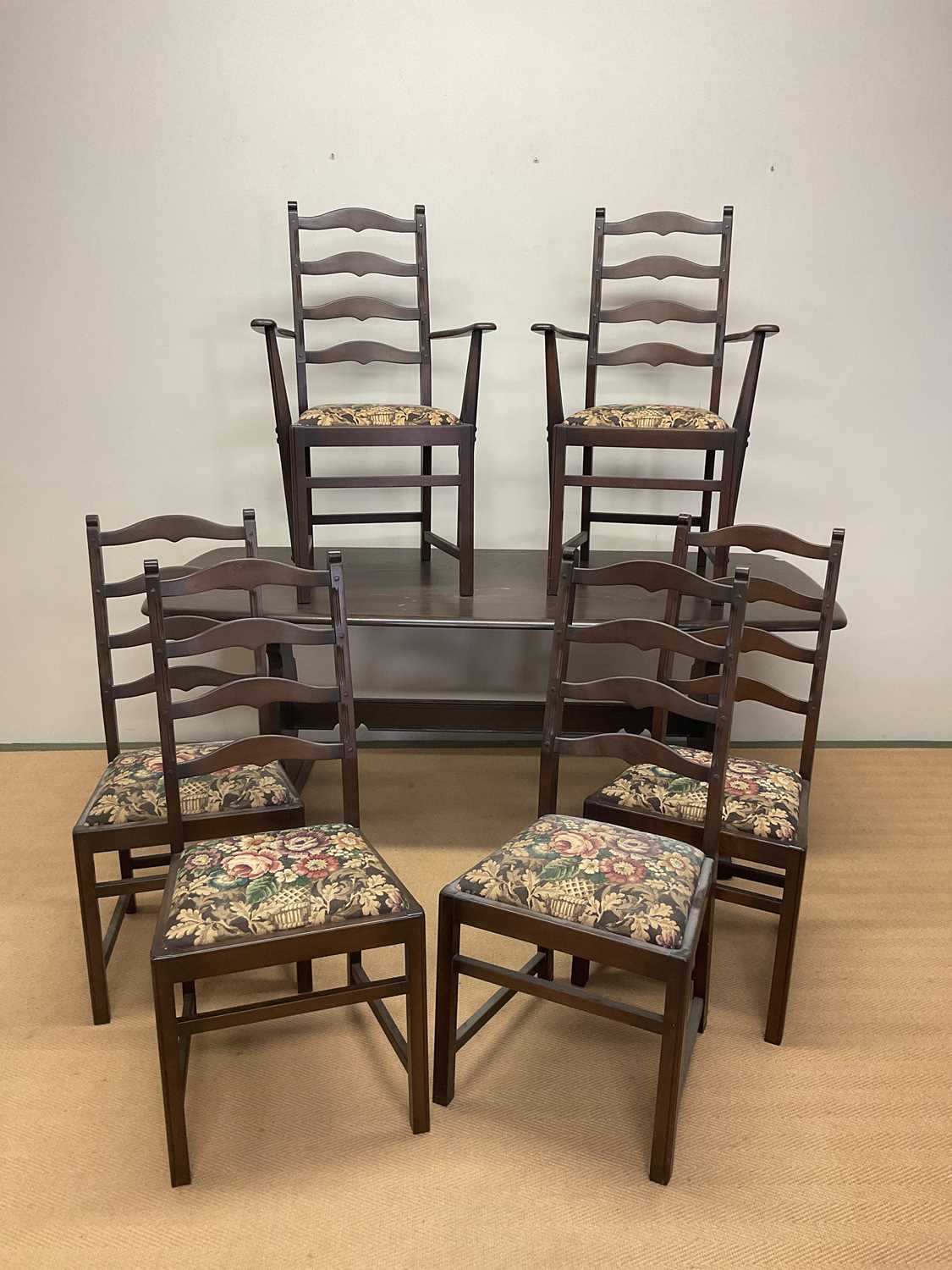 ERCOL; a dark stained table, length 180cm, width 80cm, with six chairs including two carvers with