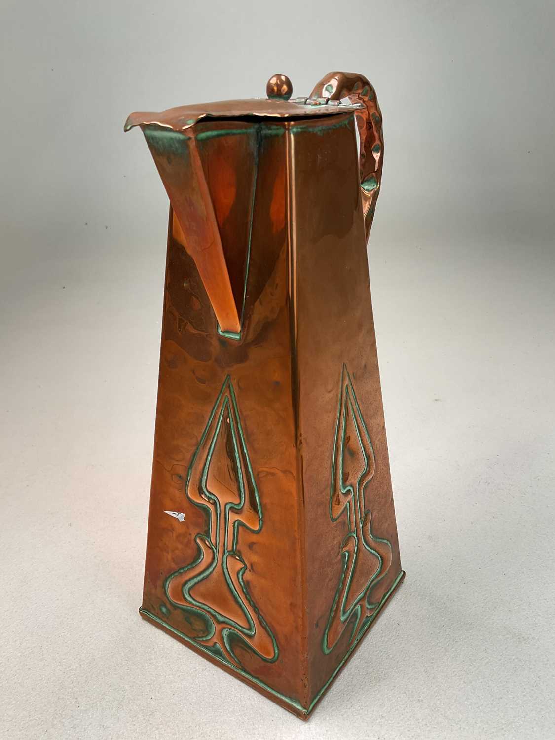 An Arts and Crafts copper water jug with tapered body embossed with stylized plants, height 28cm, - Image 3 of 4