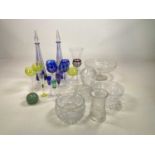 A quantity of coloured and other glass including a pair of blue cut glass decanters, glasses, vases,