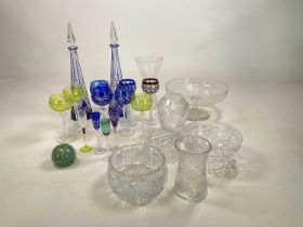 A quantity of coloured and other glass including a pair of blue cut glass decanters, glasses, vases,