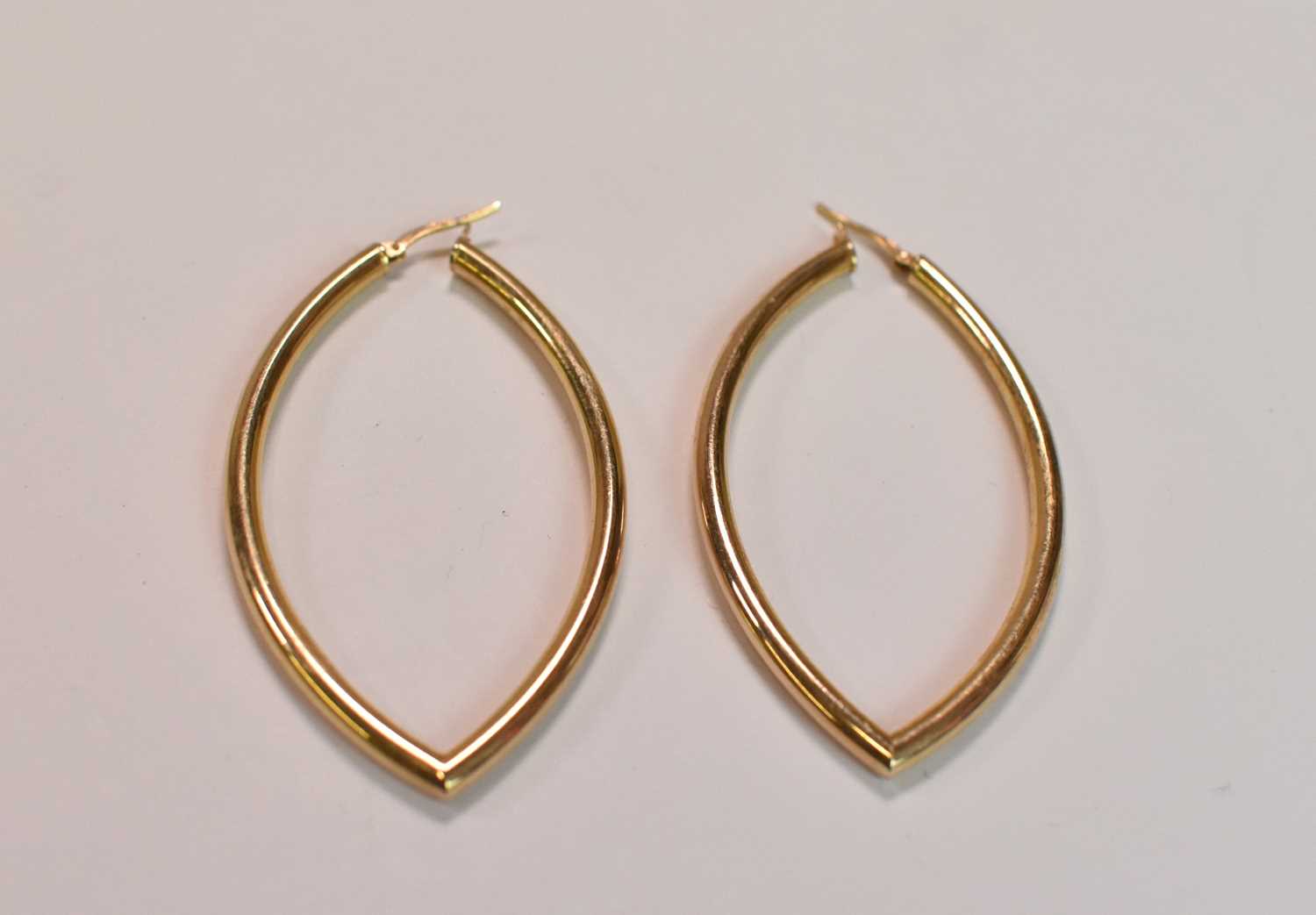 A pair of 9ct yellow gold hollow hoop earrings, combined approx 5.2g.