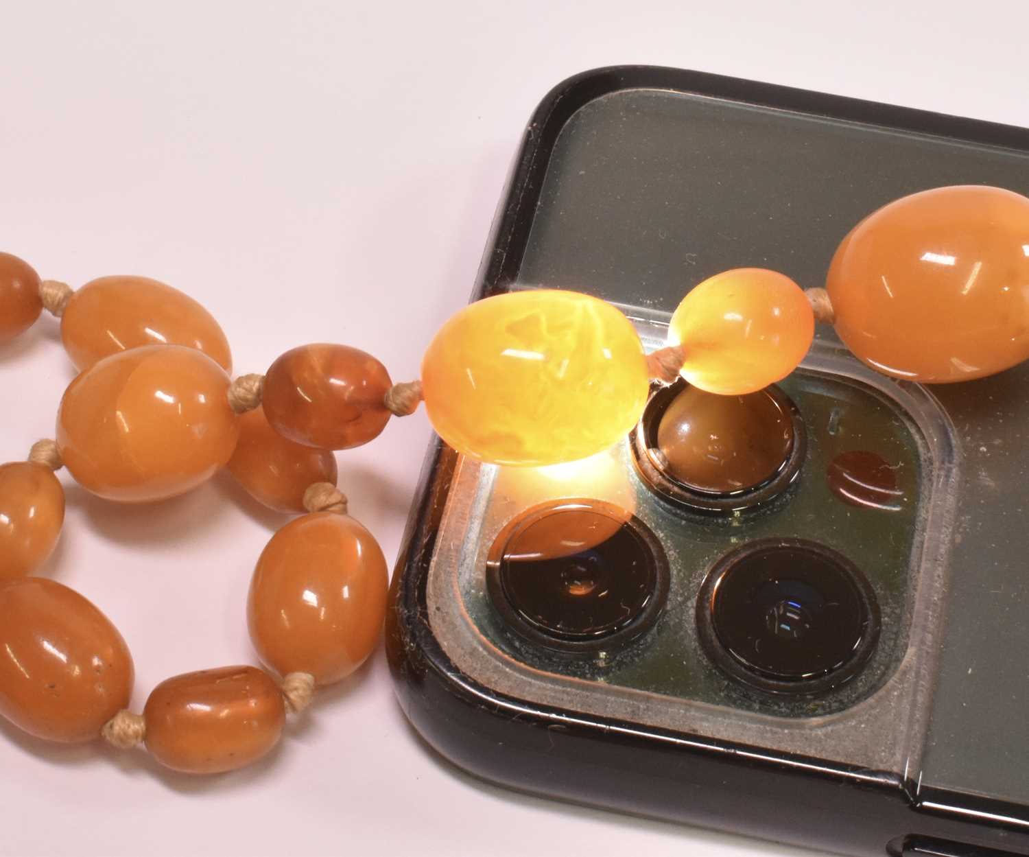 A vintage hand tied graduated butterscotch/egg yolk amber bead necklace, length 114cm, largest - Image 2 of 2