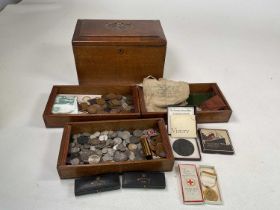 A wooden box containing British and foreign coinage, boxed Maundy coins, two Lusitania boxed replica