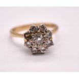 An 18ct yellow gold diamond floral cluster ring, set with eight round brilliant cut stones, each