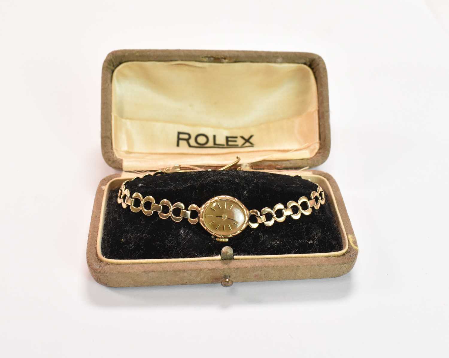 A lady's vintage 9ct yellow gold wristwatch with gold bracelet and baton markers to the oval dial,