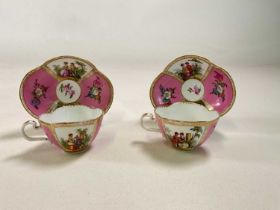A pair of Meissen inspired style quatralobed cabinet cups and saucers decorated with opposing