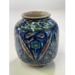 A Palestinian vase with floral and leaf decoration in shades of blue, turquoise, ochre and green,