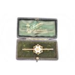 A 9ct yellow gold brooch, decorated with a fylfot, in fitted box, length 6cm, approx 1.8g (the pin