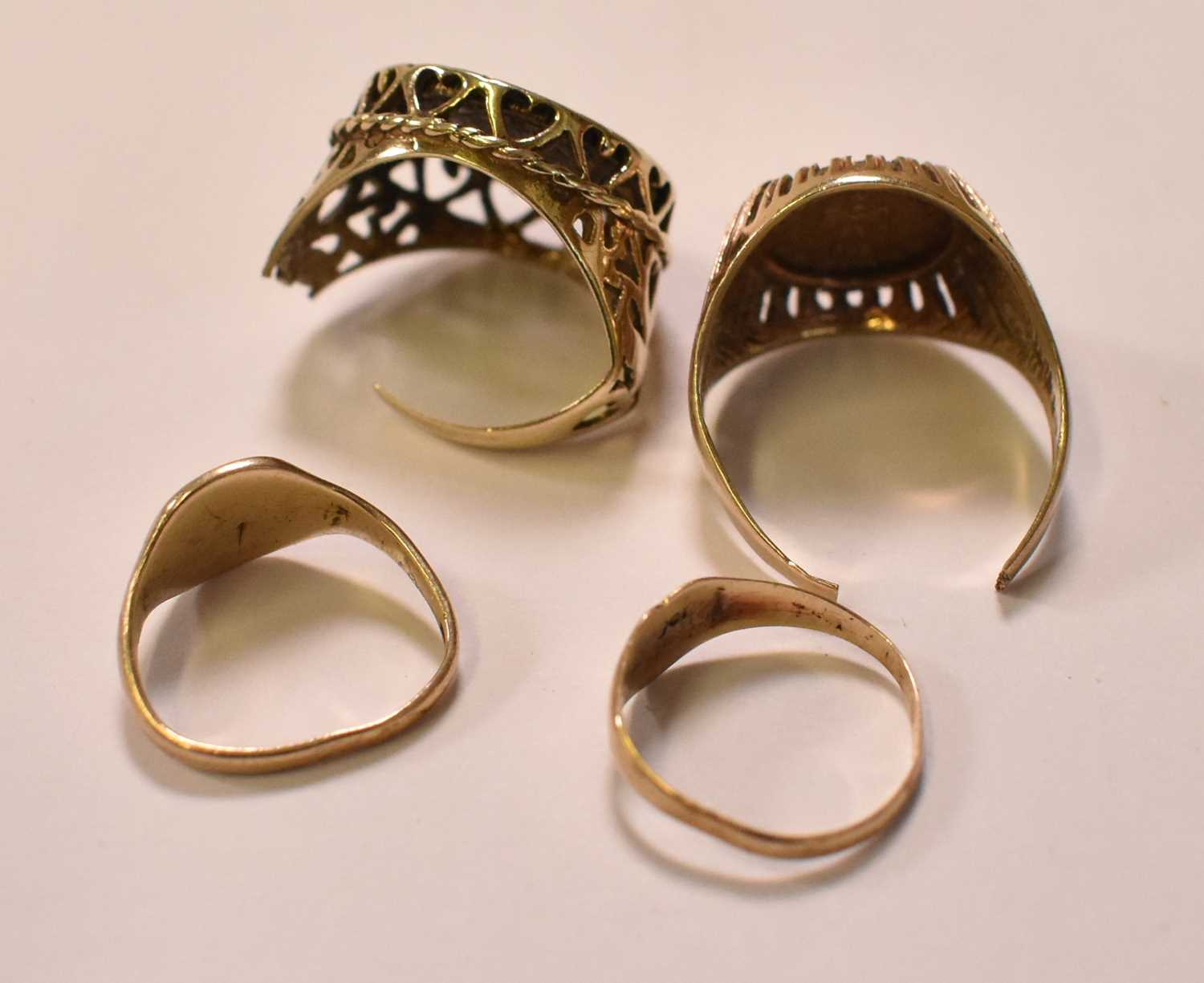 Four damaged yellow gold rings, two set with imitation 'coins', combined approx 7.6g (two badly - Image 3 of 3