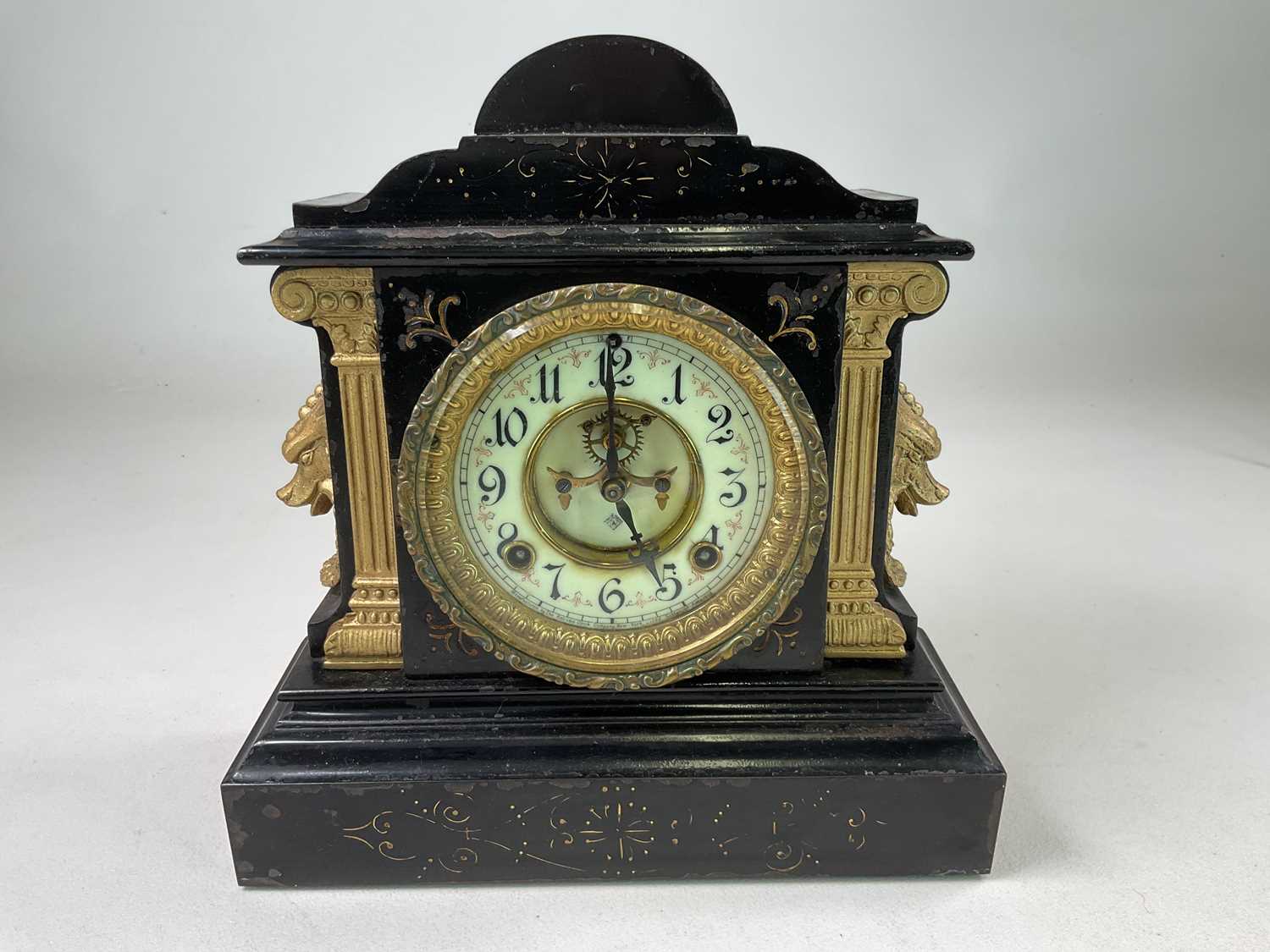 ANSONIA CLOCK CO; a mantel clock in black enamelled iron case with gilded decoration, height 31cm,